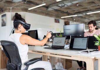 woman using laptop computer with vr headset